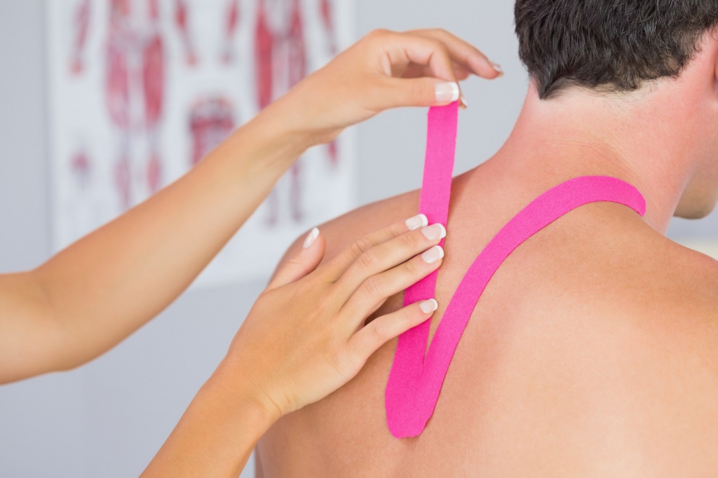 photodune-8476571-physiotherapist-putting-on-pink-kinesio-tape-on-male-patients-neck-in-bright-office-m.jpg
